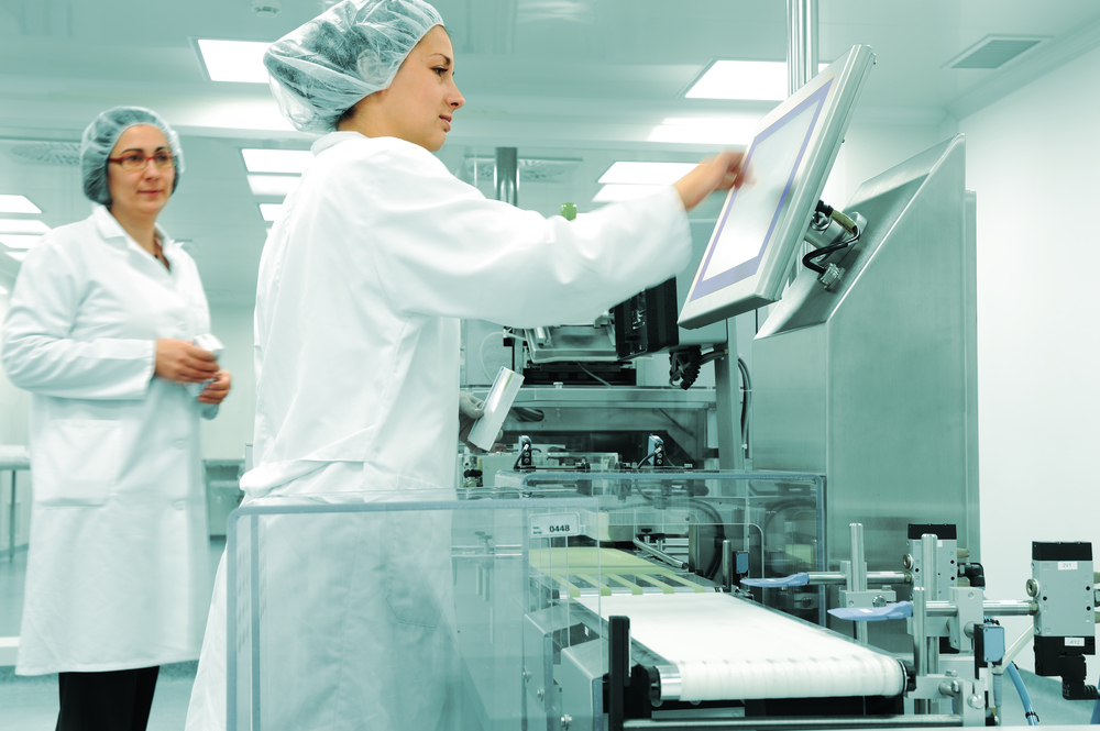 Working people at production line in modern factory