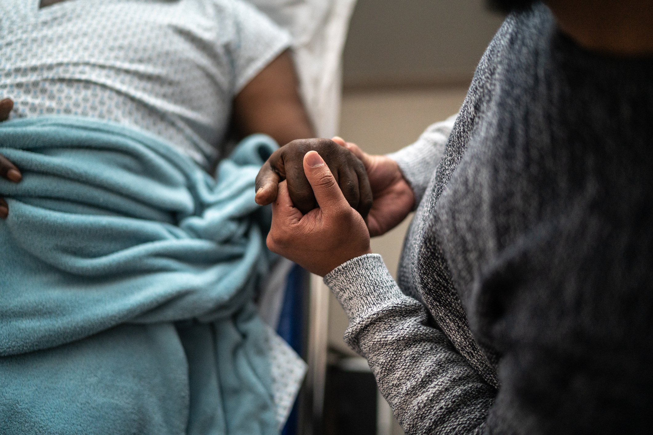 Patient in hospital holding hands
